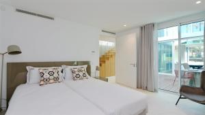 a bedroom with a white bed and a balcony at Villa Emilia - Clever Details , Central Vilamoura, Sleeps 6, luxury, walking distance in Vilamoura +34 photos