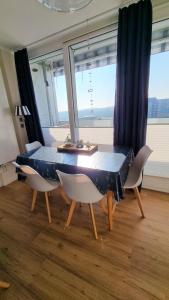 a dining room table with chairs and a blue table cloth at Ferienpark A05-008 Ferienpark in Heiligenhafen