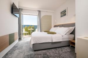 Postel nebo postele na pokoji v ubytování Hotel Villa Nova