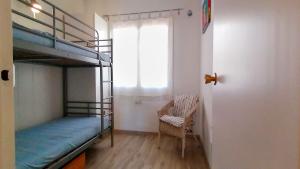 A bed or beds in a room at VACAY Apartamento Ibiza, piscina y relax! en la Costa brava, L'Escala!