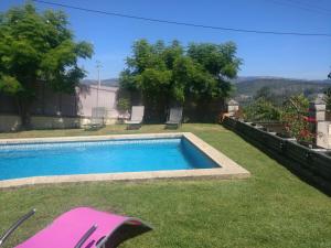 a swimming pool in the yard of a house at Moradia do Paço - Piscina Privada in Arco de Baúlhe +29 photos