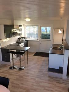 a kitchen with a table and a counter top at Hasmark beach, nice house close to the beach. in Otterup