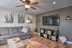 a living room with a couch and a flat screen tv at Avondale Oasis with Pool 5 Mi to State Farm Stadium in Avondale