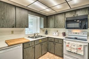 a kitchen with wooden cabinets and a sink at Punta Gorda Home with Backyard about 1 Mile to Dtwn! in Punta Gorda