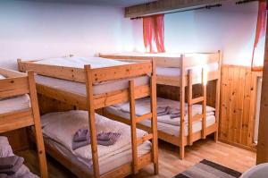 a room with three bunk beds in it at Hotel Schwarzsee in Zermatt