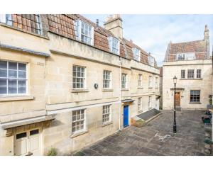 a group of old buildings with a blue door at Murphys House - 3 bed Luxury Central Townhouse in Bath