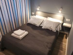 a bedroom with a bed with two towels on it at Nowa Huta in Krakow