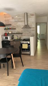 a kitchen with a table and a stove top oven at Costanera Aparts in Villa María +18 photos