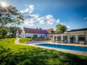 a backyard with a swimming pool and a house at OLLERS in Ollersdorf im Burgenland