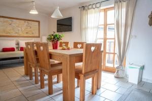 uma sala de jantar com uma mesa de madeira e cadeiras em Country House Trata em Kranjska Gora