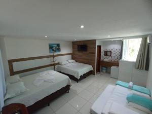 Ένα ή περισσότερα κρεβάτια σε δωμάτιο στο Suites Porto Frevo +56 φωτογραφίες