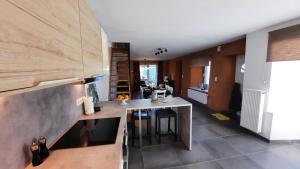 a kitchen with a counter and a table in a room at D'un coin à l'autre in Nadrin