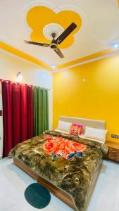 a bedroom with a bed with a ceiling fan at Rudransh home stay in Rishīkesh +32 photos