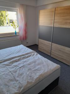 a bedroom with a bed and a dresser and a window at Locken1 in Altenau