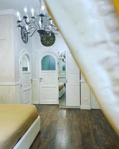 a bedroom with a bed and a chandelier at Sweet Life Trevi Roma in Rome