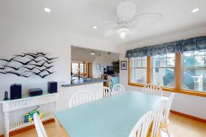 a dining room with a blue table and chairs at Sea Tower 113 in Avon