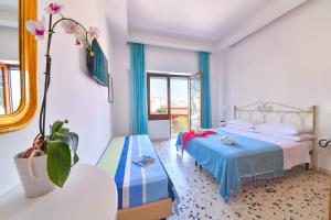 a bedroom with a bed and a potted plant at Hotel Europa in Ischia