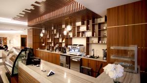 a kitchen with wooden cabinets and a counter top at Hayat Al Riyadh Washam Hotel in Riyadh