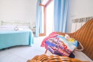 a bedroom with a bed and a chair with a blanket at Hotel Europa in Ischia