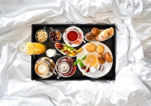 a tray of breakfast foods and drinks on a white sheet at Yacht Hotel in Vlorë