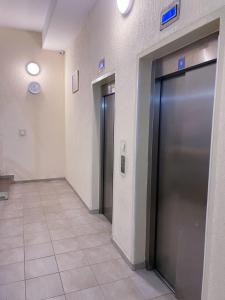 an empty hallway with two elevators in a building at Exclusive studio, great location in Podgorica