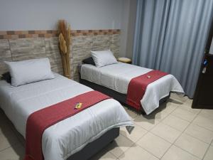 a hotel room with two beds with red and white blankets at Big D Accommodation & guesthouse in Northam
