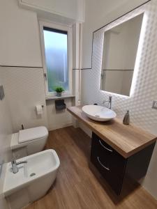 a bathroom with a sink and a toilet and a mirror at aria di mare in Sestri Levante +7 photos