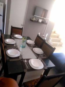 - une table à manger avec des plaques blanches au-dessus dans l'établissement Casa Vacacional Balam - en Cancún, à Cancún 6 autres photos