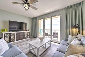 a living room with a couch and a tv and a table at Panama City Beach Condo w/ Free Beach Service! in Panama City Beach