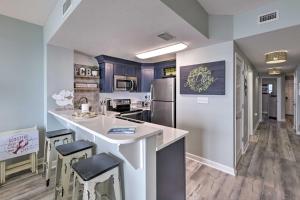 a kitchen with a counter and a refrigerator at Panama City Beach Condo w/ Free Beach Service! in Panama City Beach