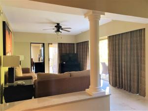 a living room with a couch and a ceiling fan at Barceló Puerto Vallarta - All Inclusive in Puerto Vallarta