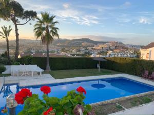 a villa with a pool and a view of the city at Espectaculares vistas a África y Gibraltar in Málaga