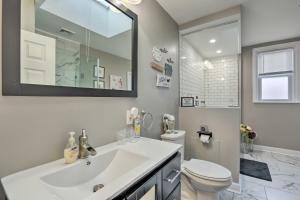 a bathroom with a sink and a toilet and a mirror at Family-Friendly Getaway 11 Mi to Dtwn Philly in Philadelphia +24 photos