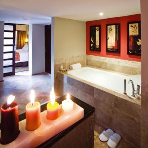 a bathroom with candles on a counter with a bath tub at Barceló Puerto Vallarta - All Inclusive in Puerto Vallarta