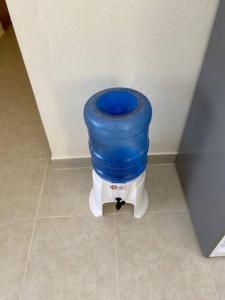 a toilet with a blue seat in a room at New Condo in Higuey - Long Term Monthly Stay! in Higuey