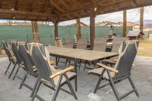 a wooden table and chairs on a patio at Pansion San in Bihać