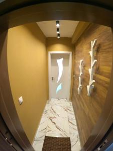 a hallway with a marble floor and a white door at Dune Apartment Nessebar in Nesebar