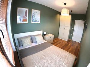 A bed or beds in a room at Dune Apartment Nessebar