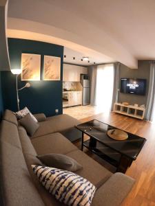 a living room with a couch and a table at Dune Apartment Nessebar in Nesebar
