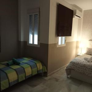 Posteľ alebo postele v izbe v ubytovaní Apartamentos centro histórico