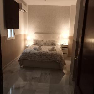 Posteľ alebo postele v izbe v ubytovaní Apartamentos centro histórico