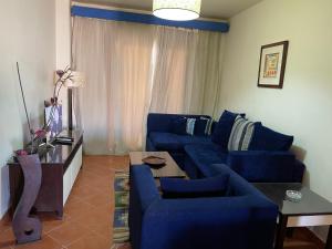 A seating area at Amazing view apartment in Golf Porto Marina with marina access