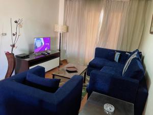 A television and/or entertainment centre at Amazing view apartment in Golf Porto Marina with marina access