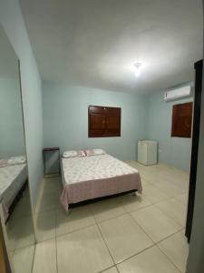 a bedroom with a bed and a mirror at Beach House Sao Jose in São José da Coroa Grande +19 photos