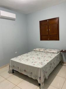 a bedroom with a bed and a cabinet at Beach House Sao Jose in São José da Coroa Grande
