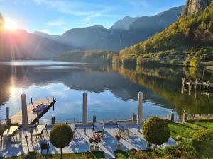 a view of a lake with a boat on a dock at B&B Hallstatt Lake OBERTRAUN self check in in Obertraun