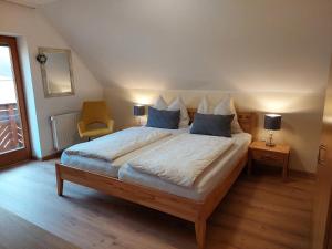 a bedroom with a large bed with blue pillows at Anna's Home - Ferienwohnungen in Ratsch an der Weinstraße
