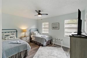 a bedroom with two beds and a ceiling fan at #49 Cheerful 2 BDR with Pool & Assigned 2 Parking in Hilton Head Island +29 photos