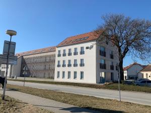 a white building on the side of a street at Apartmány Speicher in Mikulov