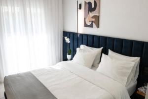 a bedroom with a large white bed with white pillows at Veria Suite in Veria